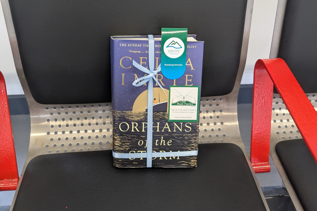 A book wrapped in ribbon on a seat